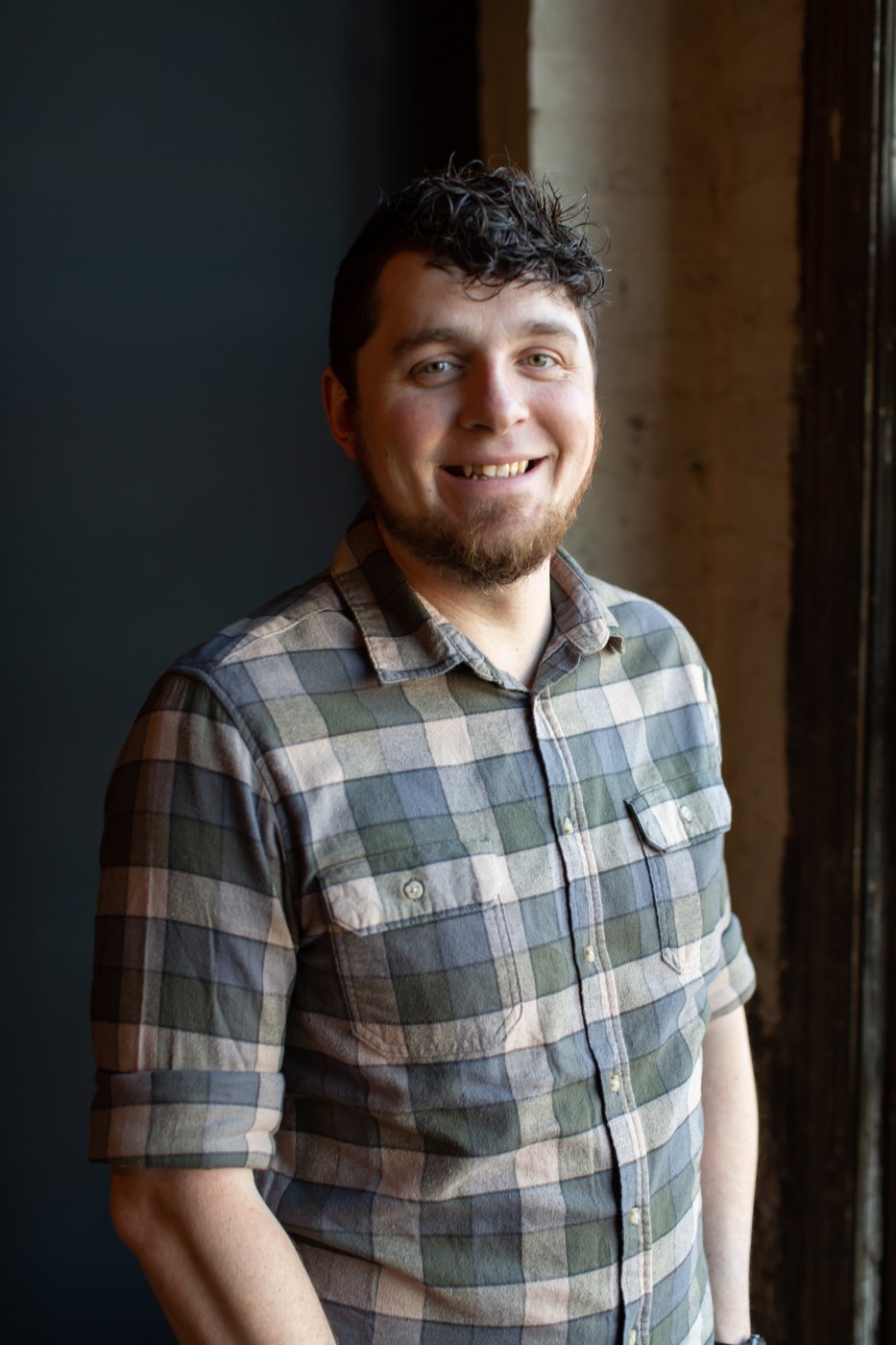 Josh Reed, LPCC-S, standing beside a window